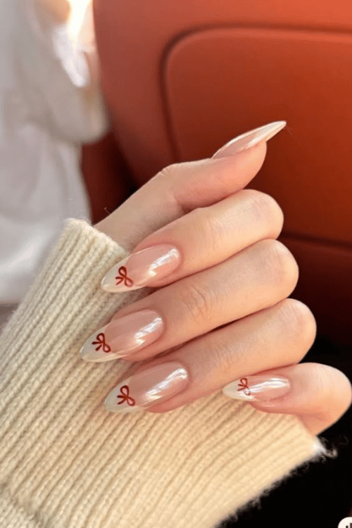 White French Tips with Red Bows | 22 Red Christmas Nails So Festive Even Rudolph Would Be Jealous