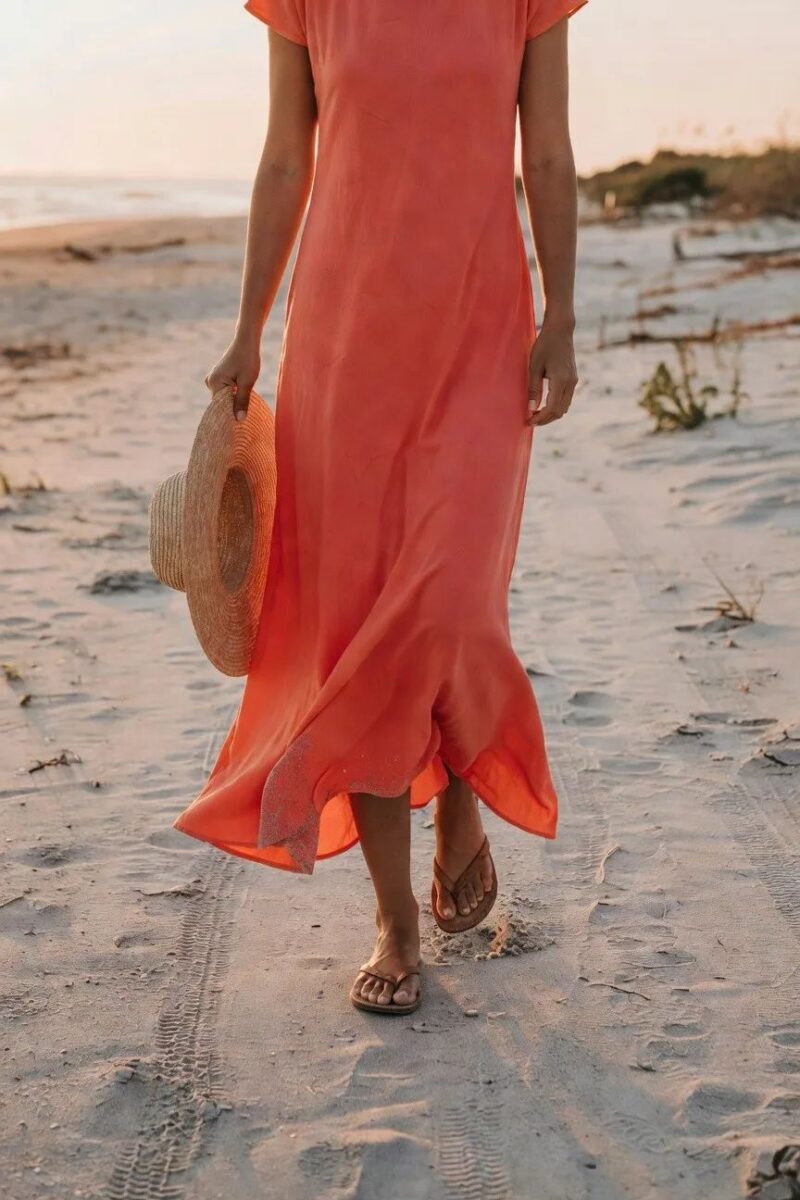 coral maxi dress with a straw hat