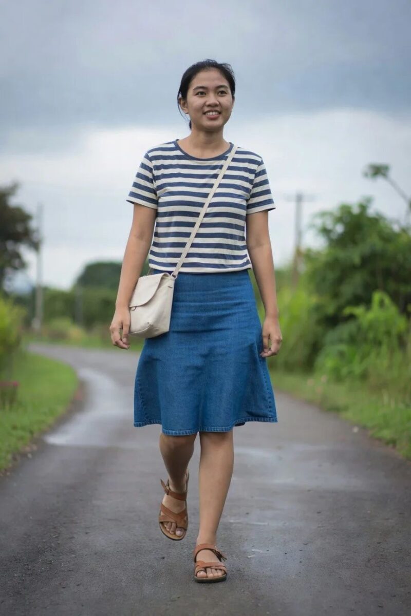 striped top paired with a flared denim skirt