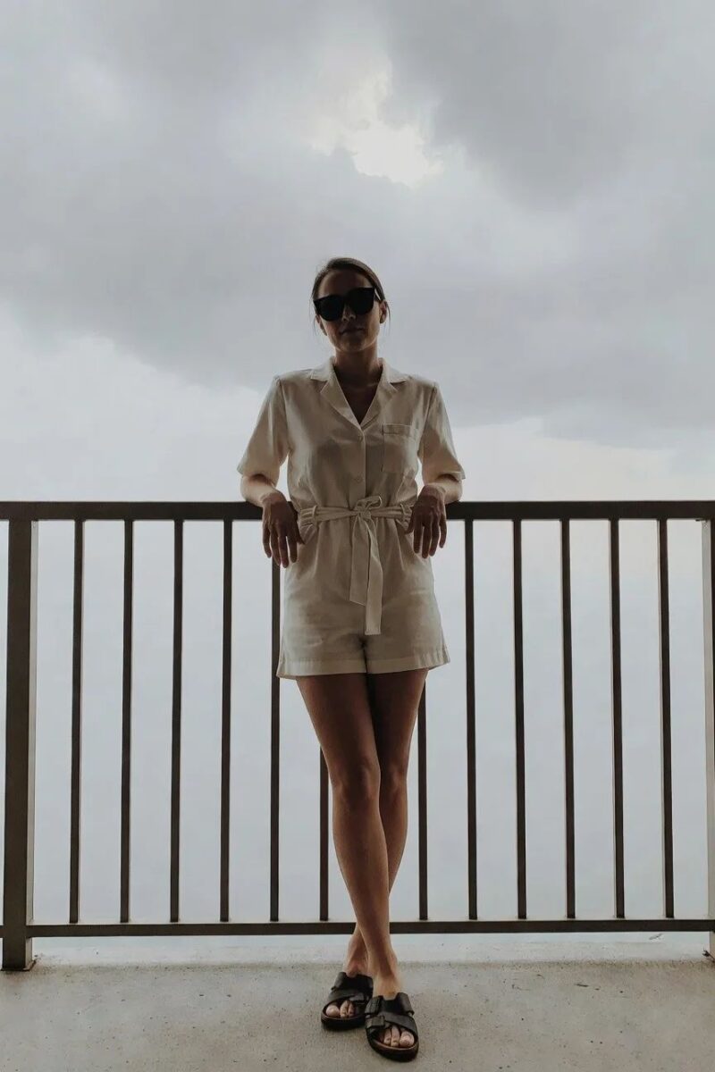 cream belted romper with black sandals