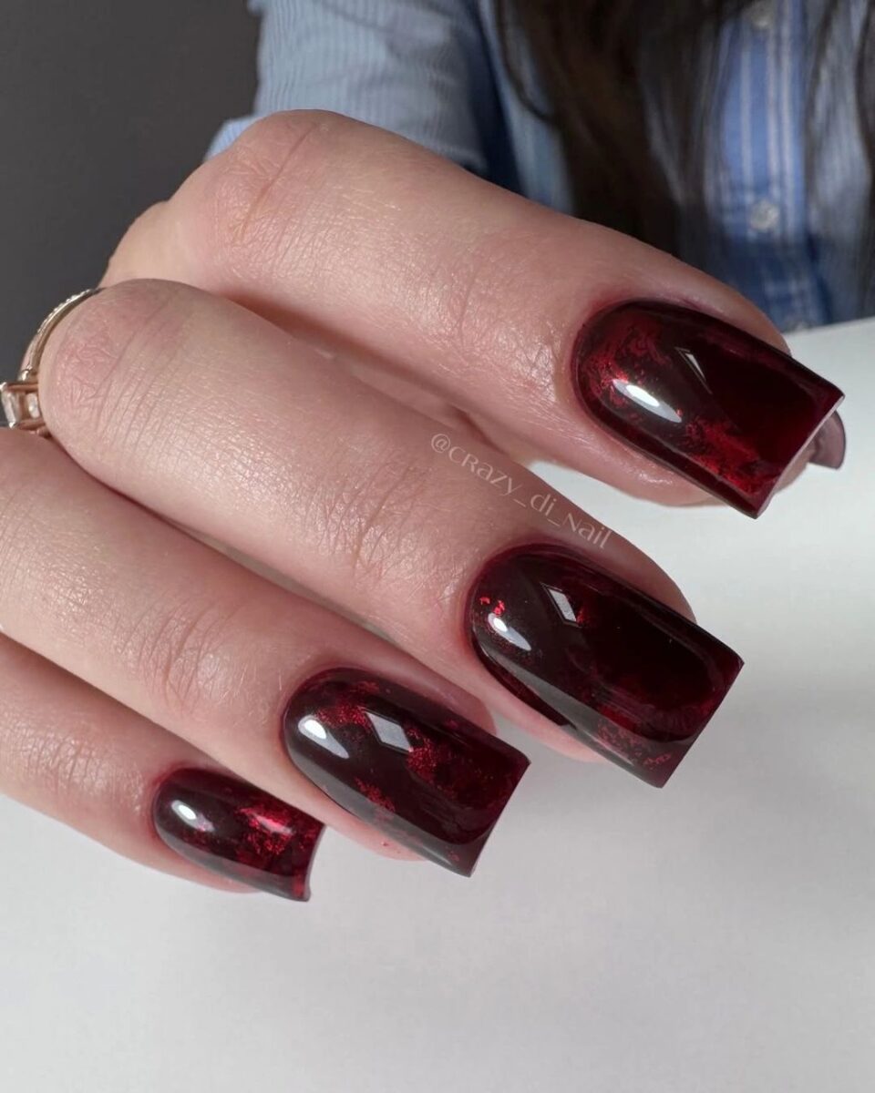 Medium burgundy square nails with elongated reflective highlights