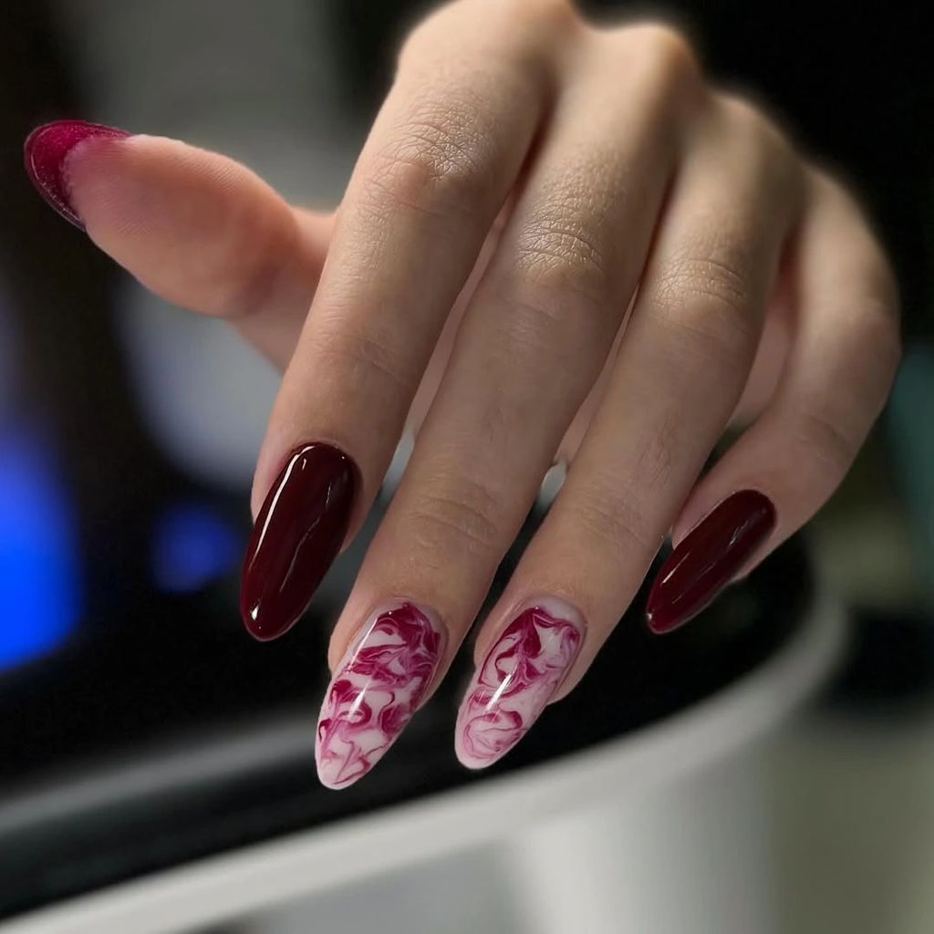 Long burgundy nails with two pale pink red marble accents | Gorgeous Fall Burgundy Nail Designs: 21 Wine-Toned Ideas to Try