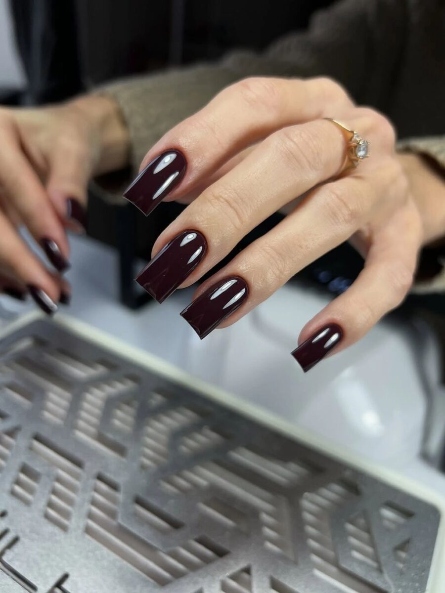 Long glossy burgundy square nails with architectural straight tips