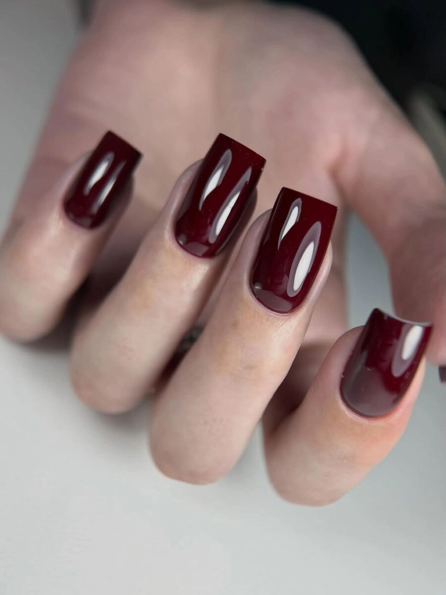 Long burgundy square nails with elongated light reflective panels