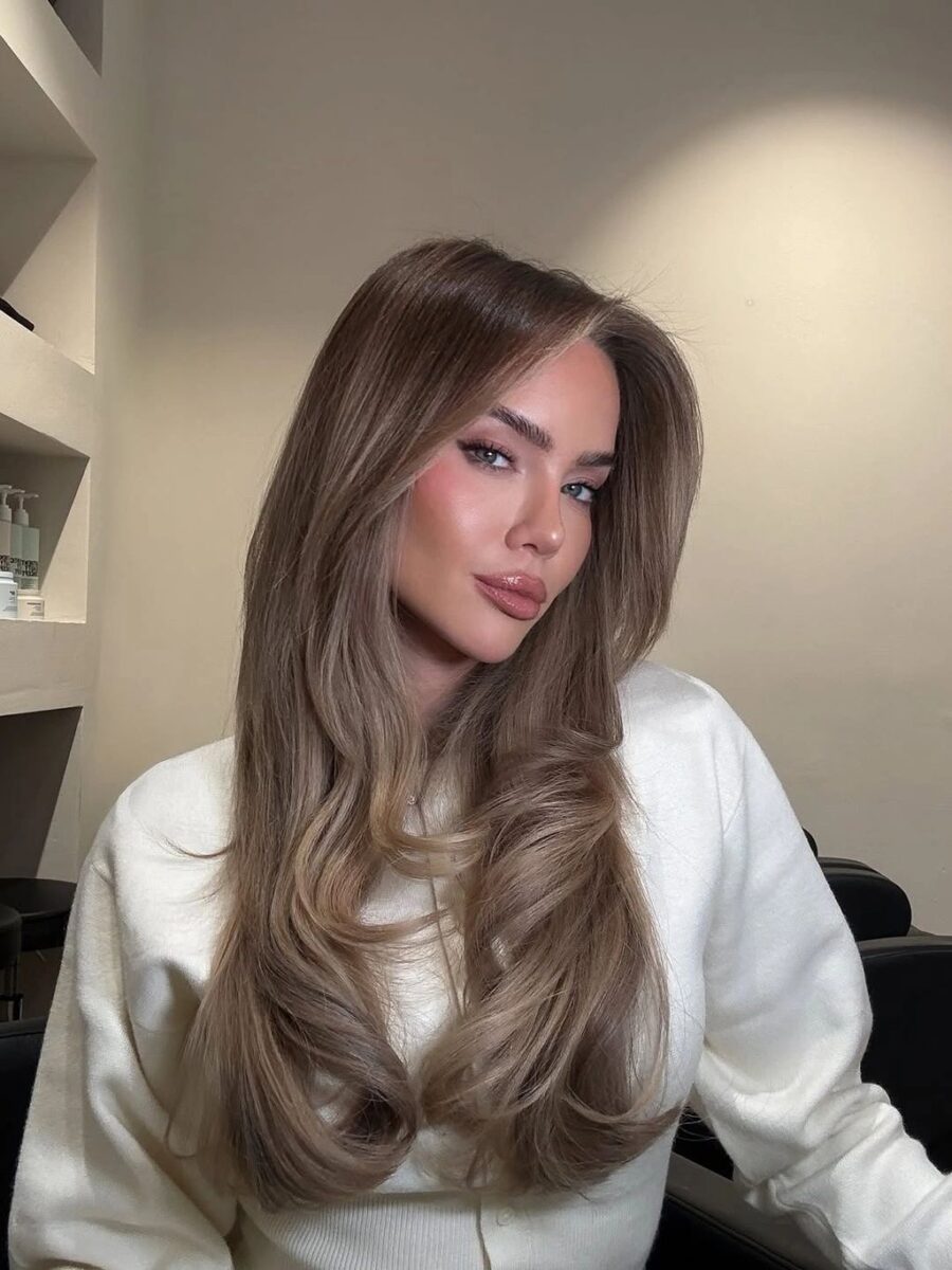 Long cool taupe waves with soft face-framing pieces