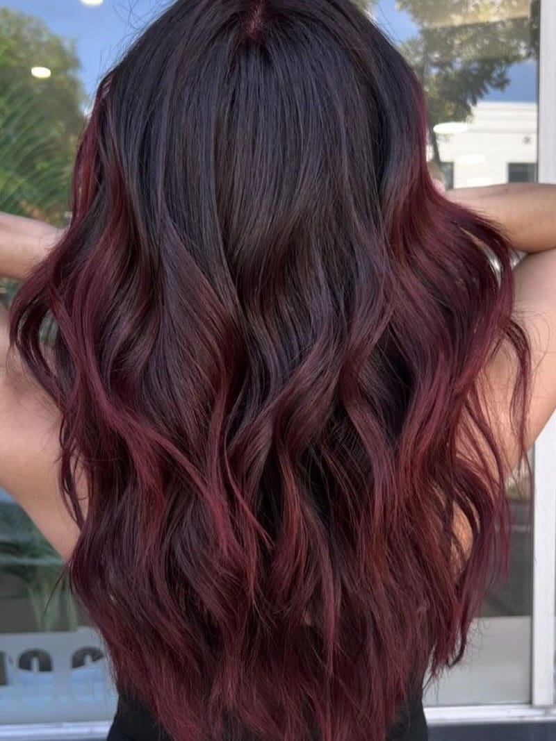 Long dark waves with wine-red ribbon highlights through lengths | Gorgeous September Hair Colour Ideas for a Fresh Autumn Refresh