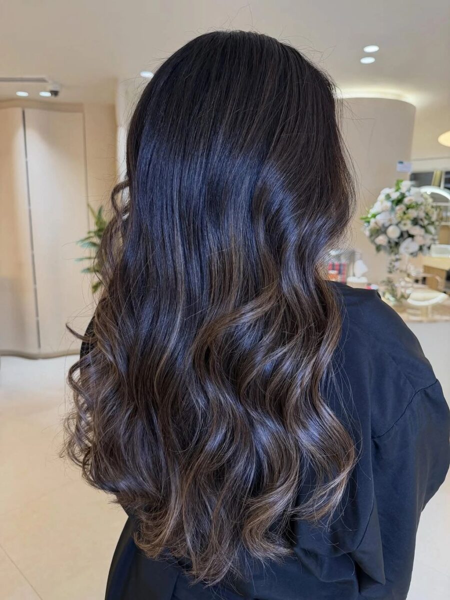 Dark long waves with cool blue-violet highlight ribbons