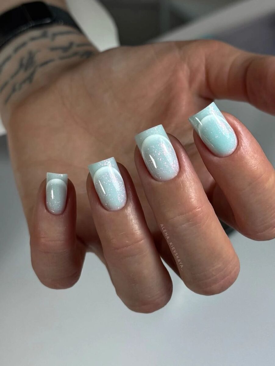Short icy blue square nails with a soft reflective finish
