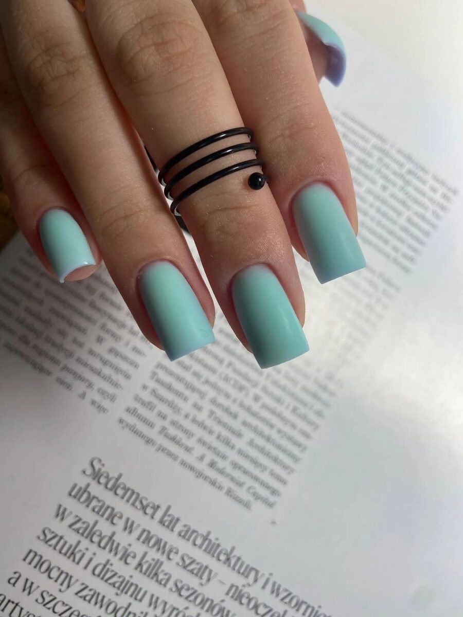 Short muted teal square nails with a clean glossy finish