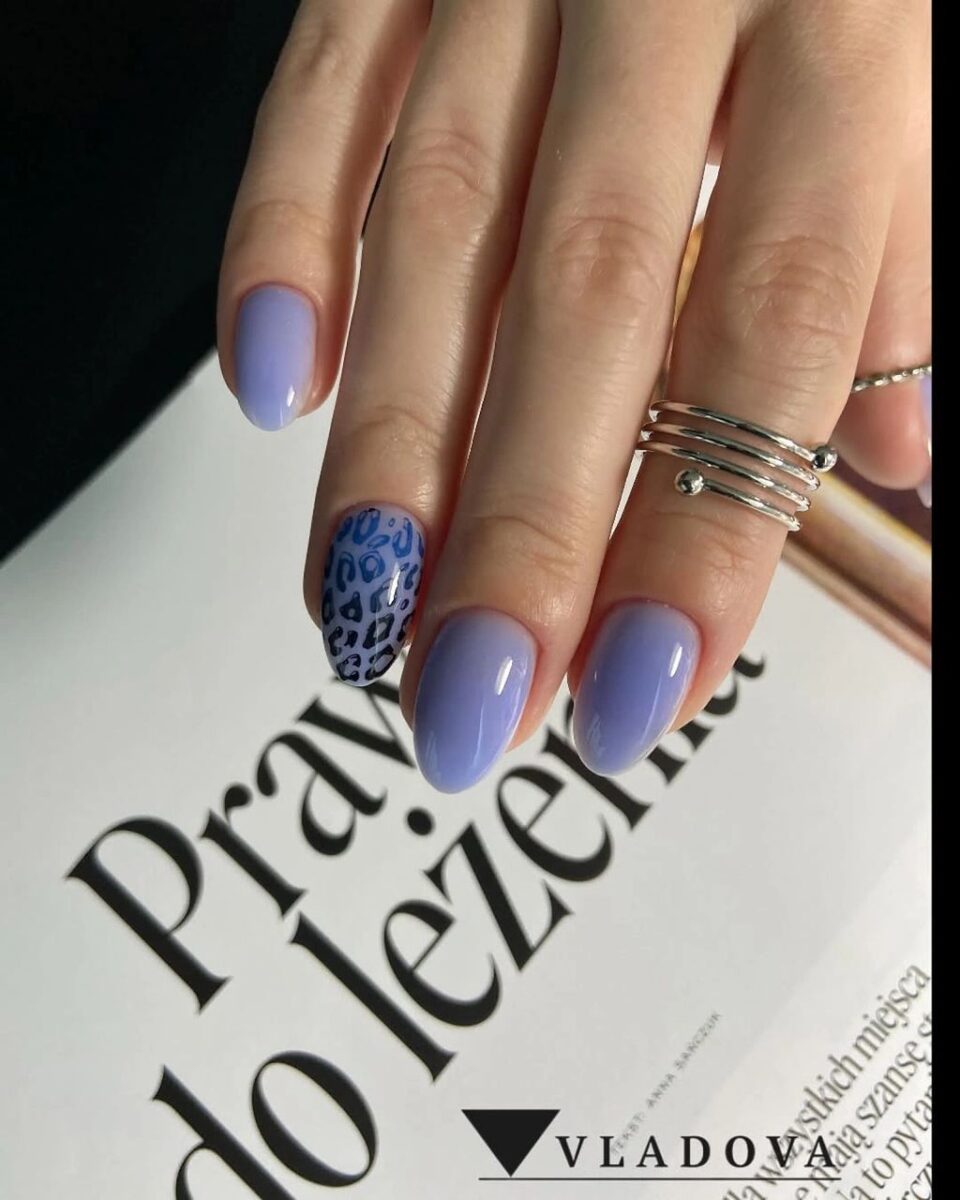 Short lavender nails with one blue spotted accent nail