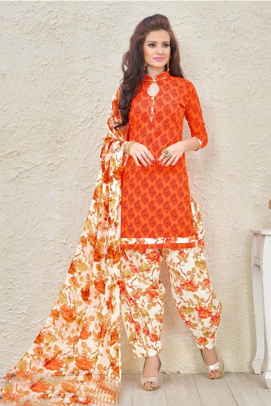 Woman in an orange block-print kurta with floral palazzo trousers and a matching floral dupatta