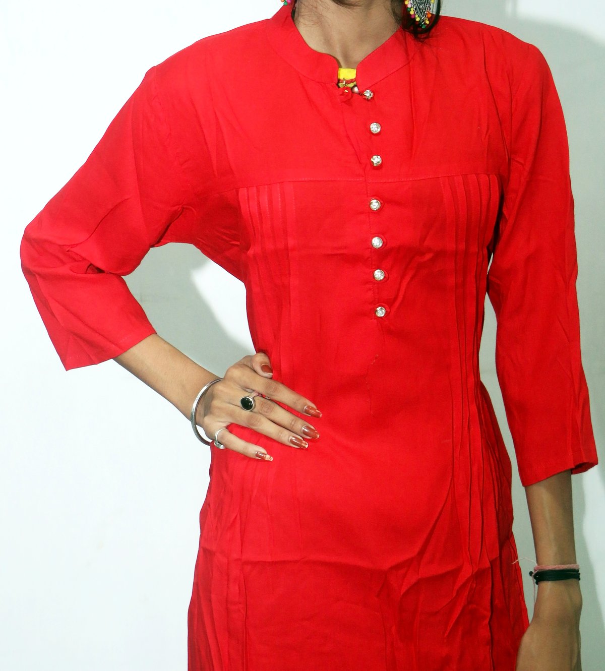 Woman wearing a solid red kurti with pintuck detailing