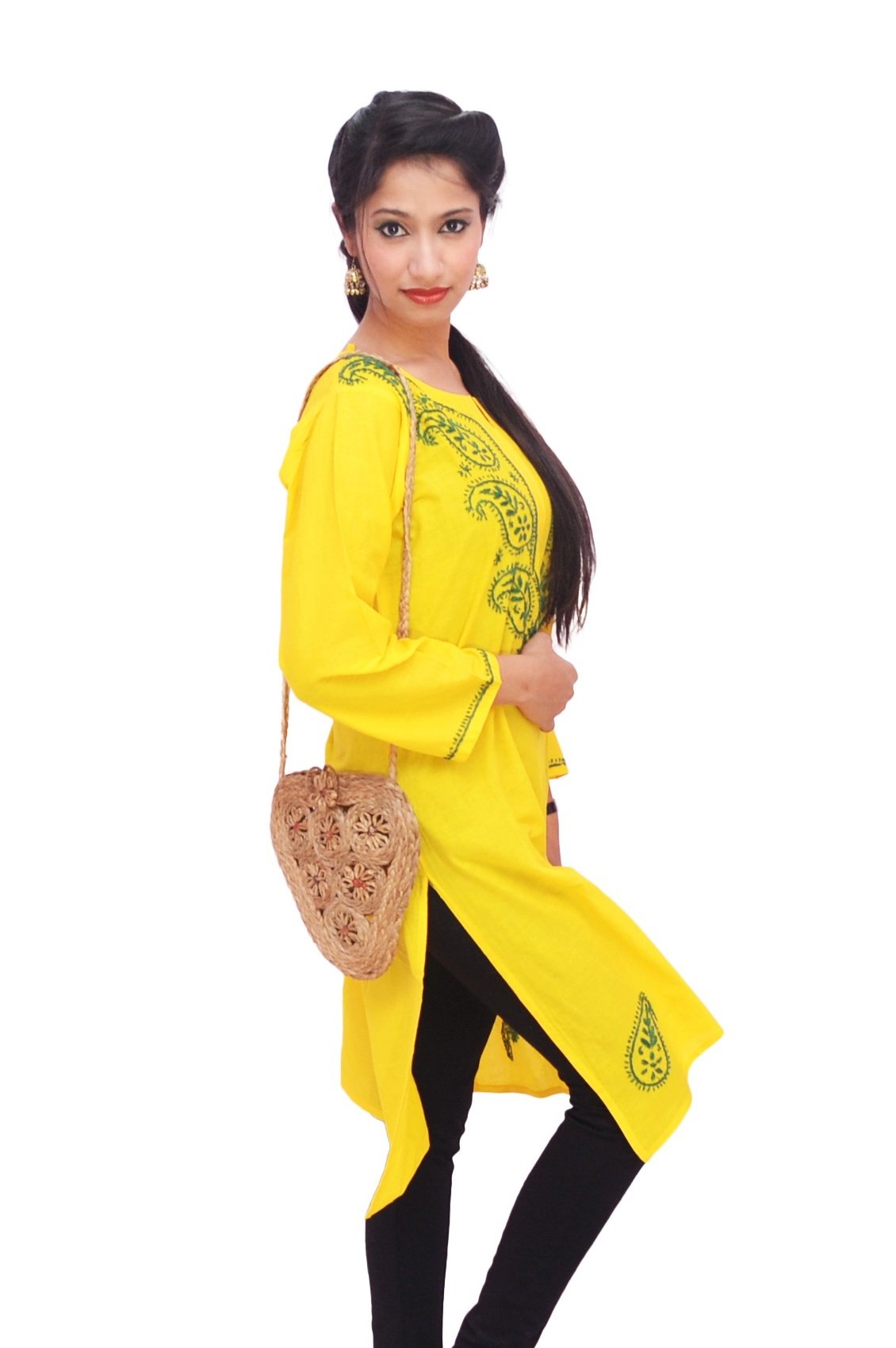 Woman in a yellow embroidered kurti with black leggings and a jute sling bag