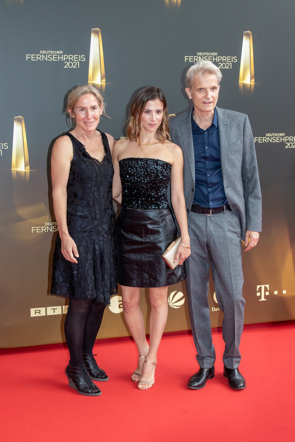 Actress Aylin Tezel on the red carpet in a strapless black sequin mini dress with strappy heels