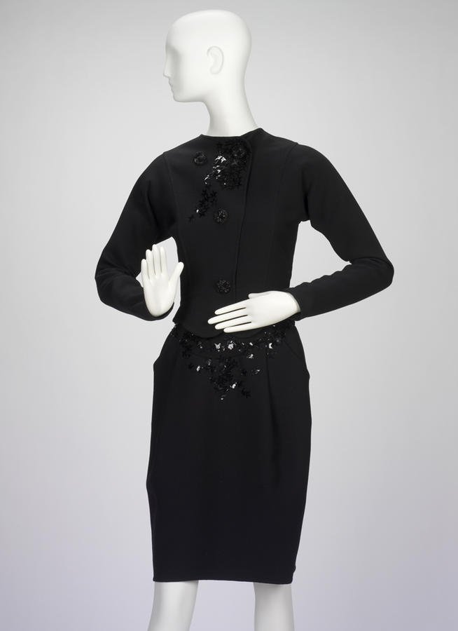 A 1987 Geoffrey Beene black cocktail dress with sequin accents photographed on a mannequin