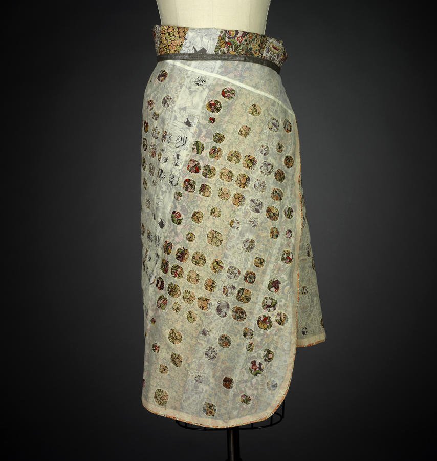 Floral-appliqué wrap skirt displayed on a dress form