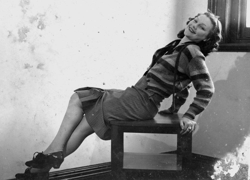 Striped cardigan worn buttoned up with a high-waisted pinstripe skirt