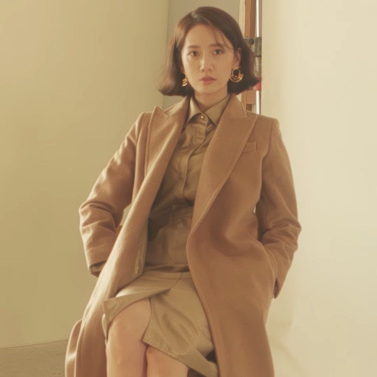 Tonal camel coat with blouse and skirt